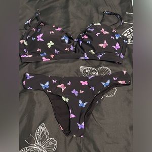 Black with butterfly’s, size, XL top, M bottoms